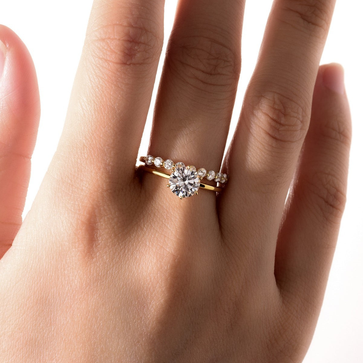Round brilliant moissanite crown solitaire and bubble band stacking ring set in platinum plated silver.