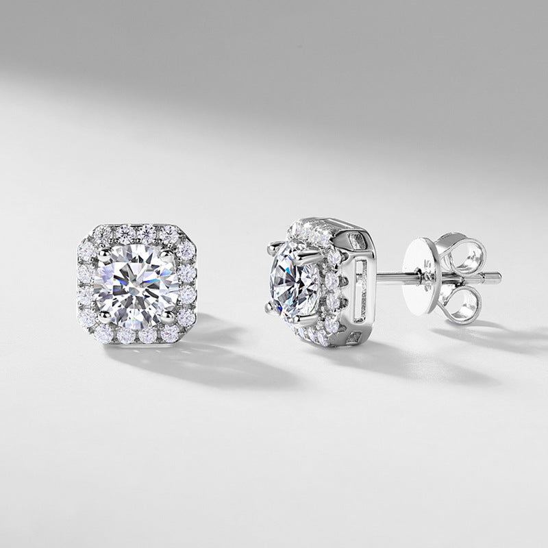 Angled view of cushion halo stud earrings showing stone basket and friction backs.
