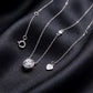 Round cut lab grown diamond halo pendant necklace showing chain and clasp on dark black silk