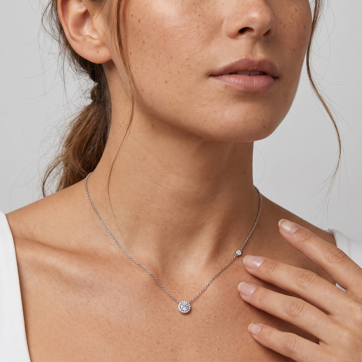 Model wearing round cut lab grown diamond halo pendant necklace