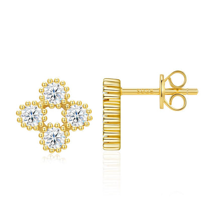 Gold round cut moissanite four-leaf clover stud earrings with beaded milgrain border on white background.