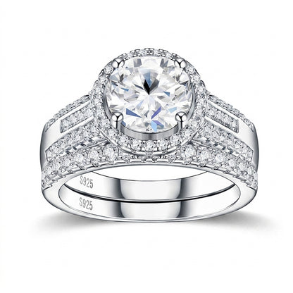 Round cut moissanite halo engagement ring with multi-row pave matching band on white background.