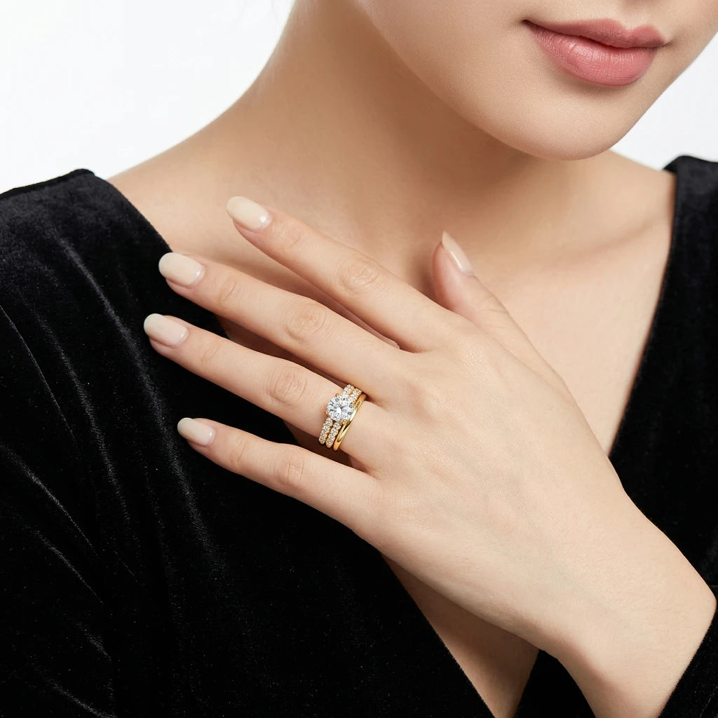 Close-up view of round moissanite solitaire double pavé ring set styled with black dress.