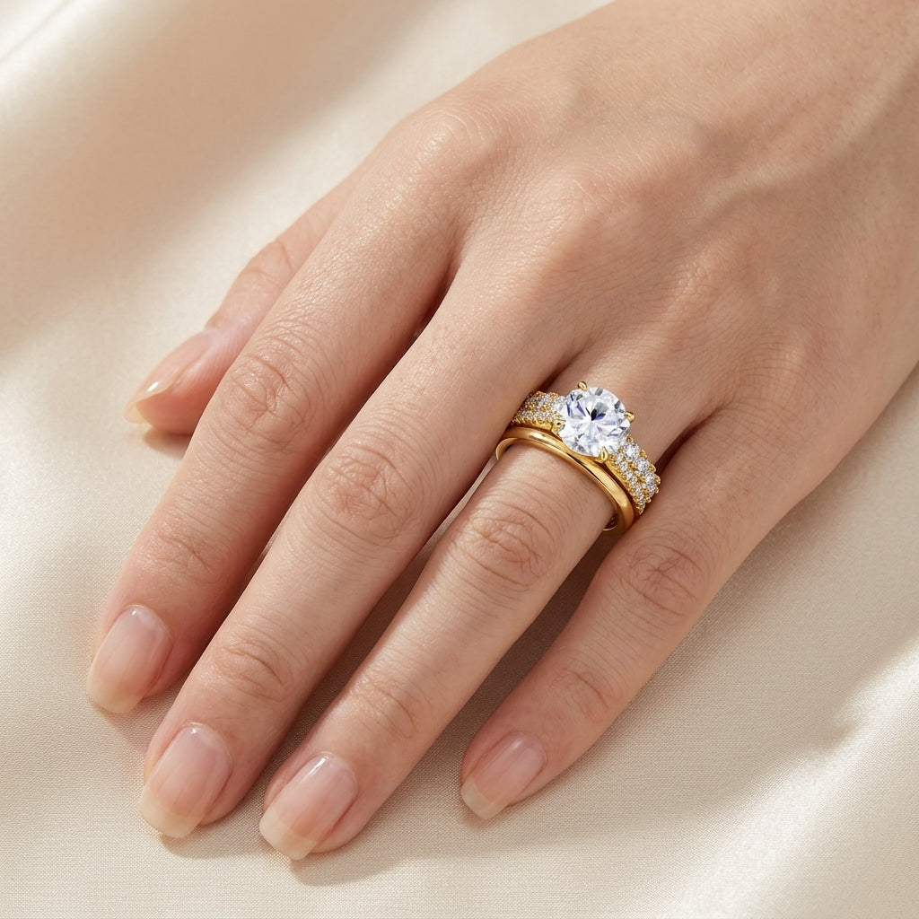 Model wearing round cut moissanite solitaire double pavé stackable ring set.