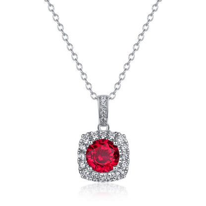 Elegant round-cut ruby square frame pendant necklace with a brilliant diamond halo on a sterling silver chain.