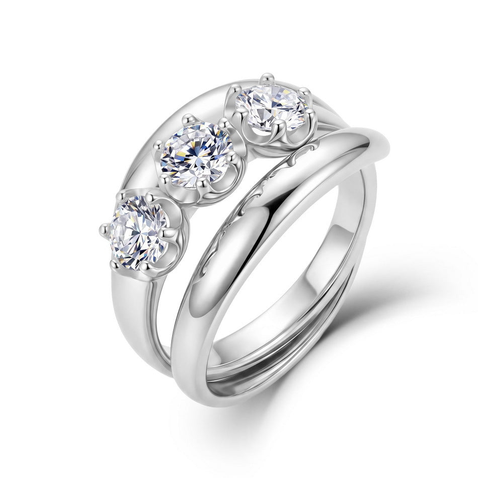 Round cut three-stone engagement ring and curved guard band set in 925 silver.
