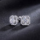 Perspective close-up view of round lab diamond baguette halo stud earrings on dark silk.
