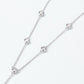 Close-up view of round diamond bezel-set stations along delicate cable chain.