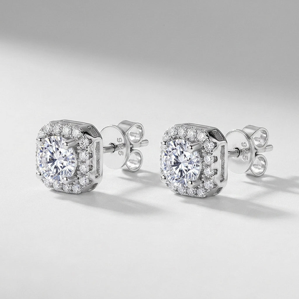 Pair of round diamond cushion halo stud earrings in platinum-plated 925 sterling silver.