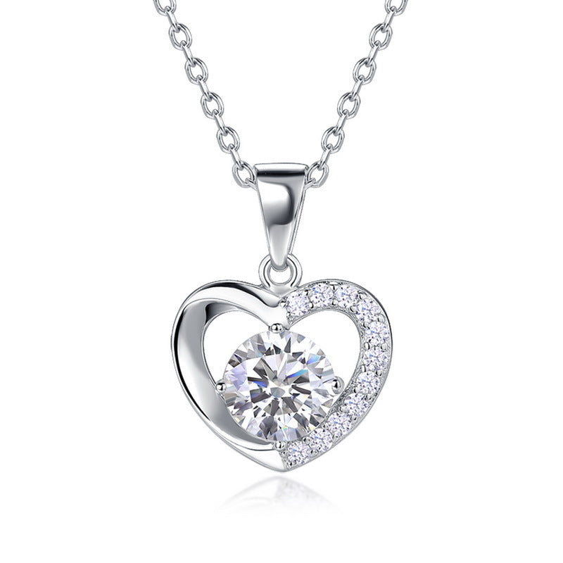 Round cut diamond floating heart solitaire pendant necklace with half-pavé frame in 925 silver.