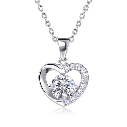 Round cut diamond floating heart solitaire pendant necklace with half-pavé frame in 925 silver.