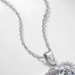 Angled close-up of round diamond floating heart pendant showing bail and half-pavé setting.