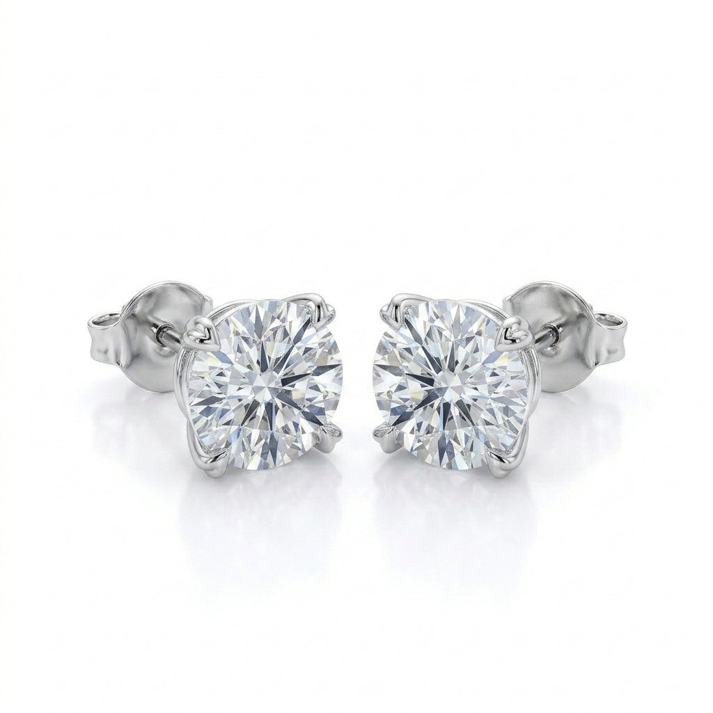 Frontal view of round diamond solitaire stud earrings with romantic heart shaped prongs.