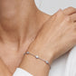 Model wearing round cut lab grown diamond bezel set station chain bracelet.