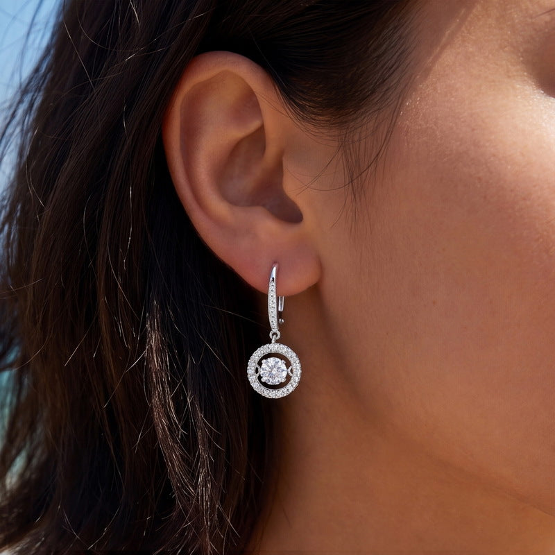 Model wearing round lab diamond circle halo dangle leverback earrings.