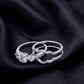 Separated view of 3-stone engagement ring and contour wave enhancer band on dark silk.