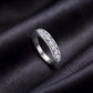 Perspective view of round lab-grown diamond channel set wedding band ring on dark silk.