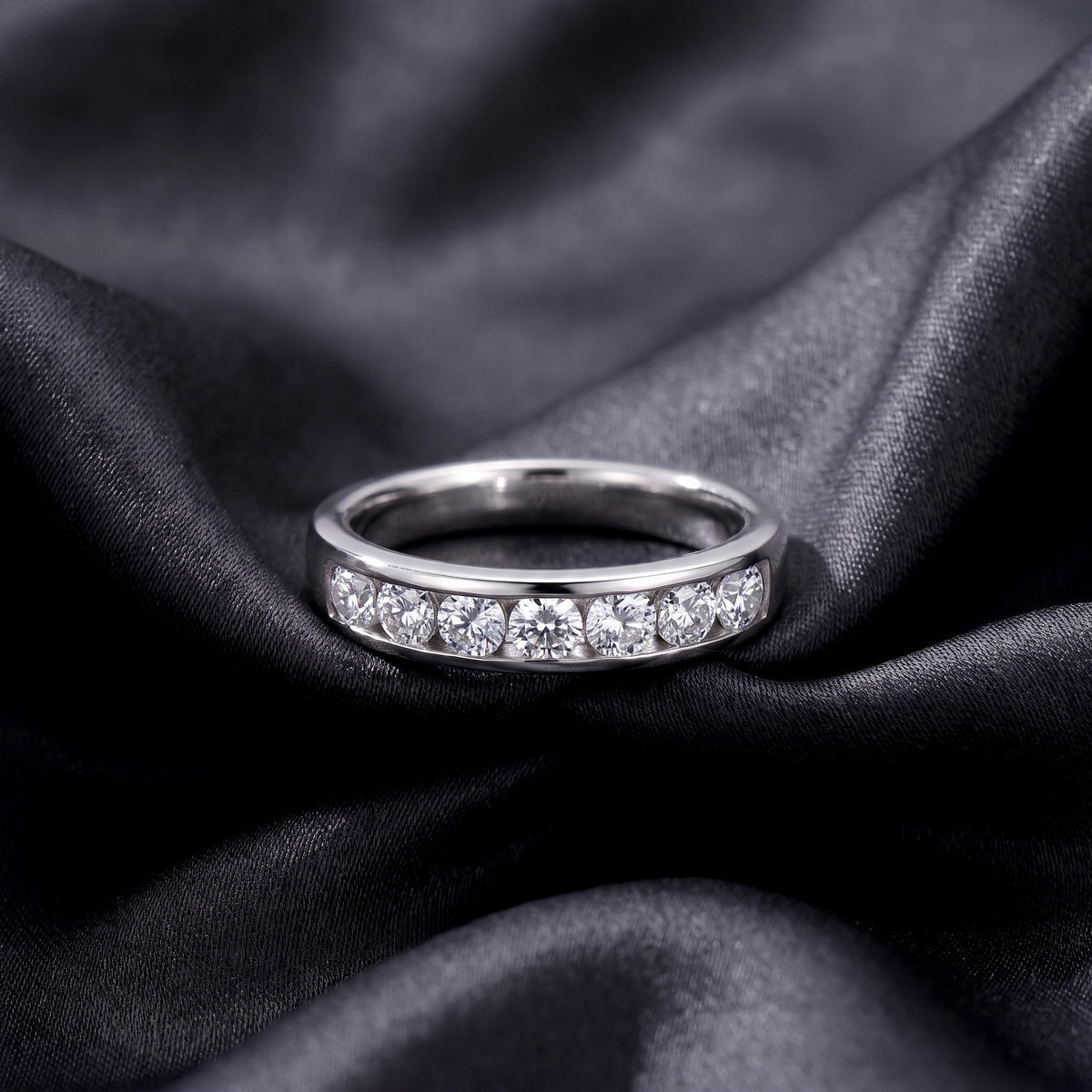 Frontal view of round lab-grown diamond channel set wedding band ring.