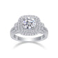 Front view showing round moissanite centerpiece framed by cushion double halo and pave split shank.