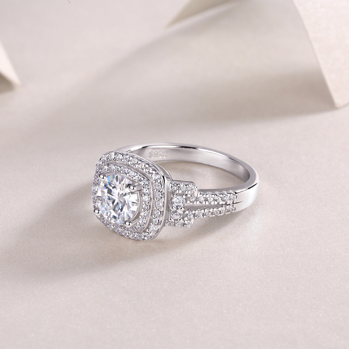 Angled side display of cushion double halo moissanite engagement ring.