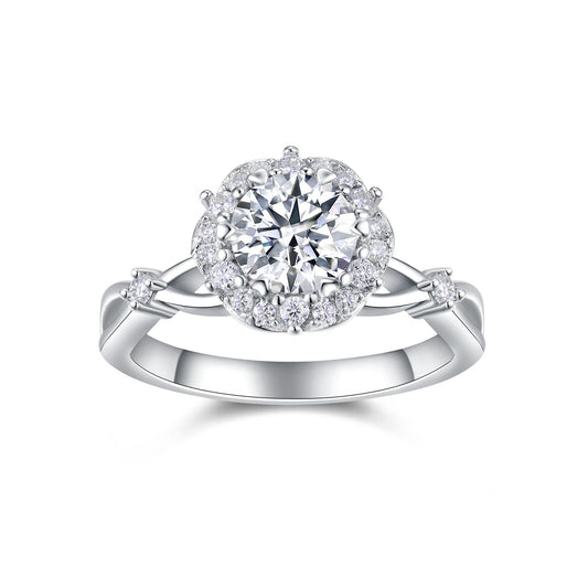 Round moissanite floral halo ring with vine twisted shank on white background.
