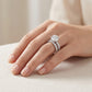 Model wearing round cut moissanite hidden halo stacked bridal ring set in soft ambient lighting.