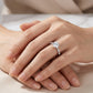 Model showing round cut moissanite marquise leaf station engagement ring on hand.