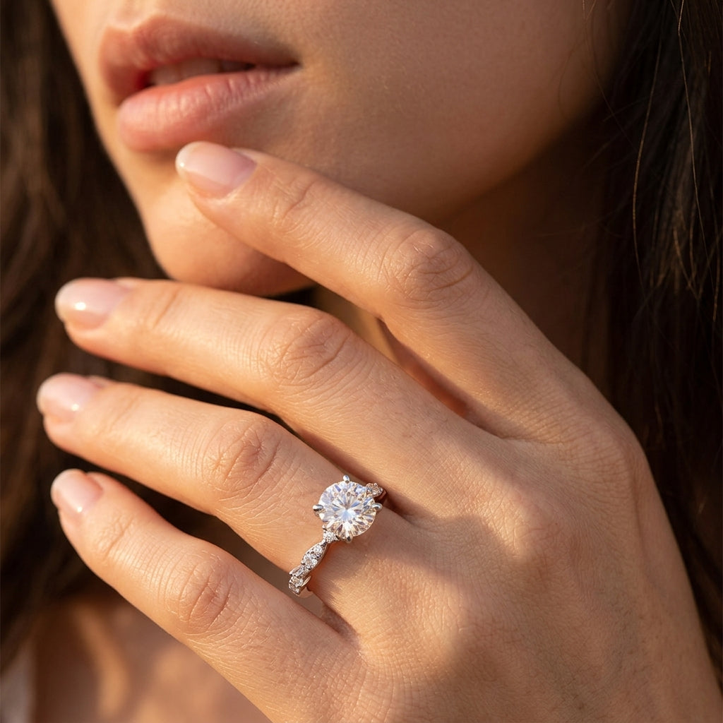 Close-up view of a model wearing round moissanite engagement ring with marquise leaf band.