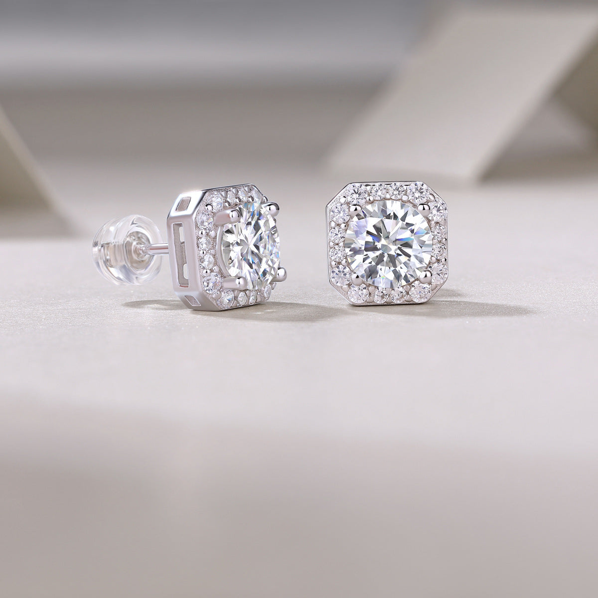 Back and side view showing openwork gallery architecture of octagon halo moissanite studs.