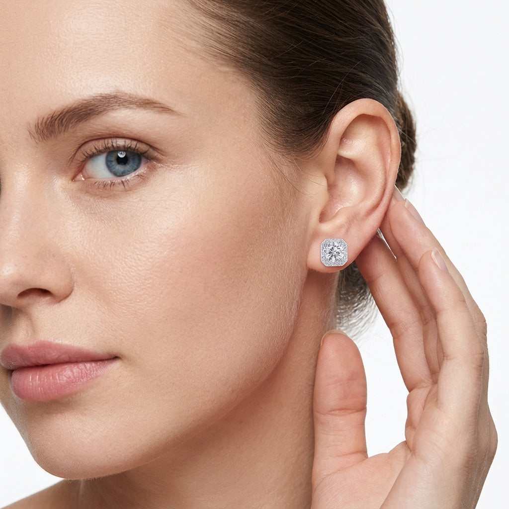 Model showing round cut moissanite cushion halo studs with octagon frame on ear.