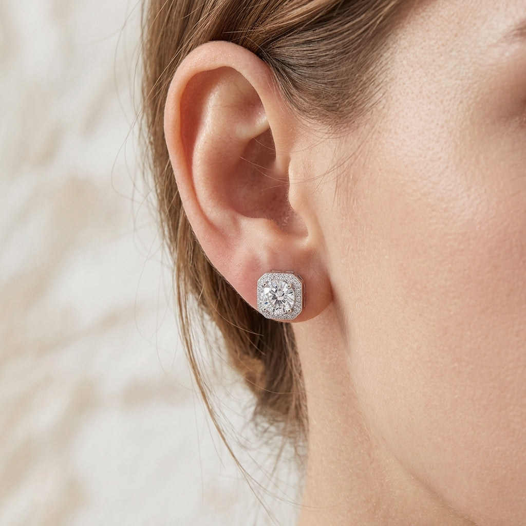 Close-up view of a model wearing round cut moissanite octagon halo stud earring.