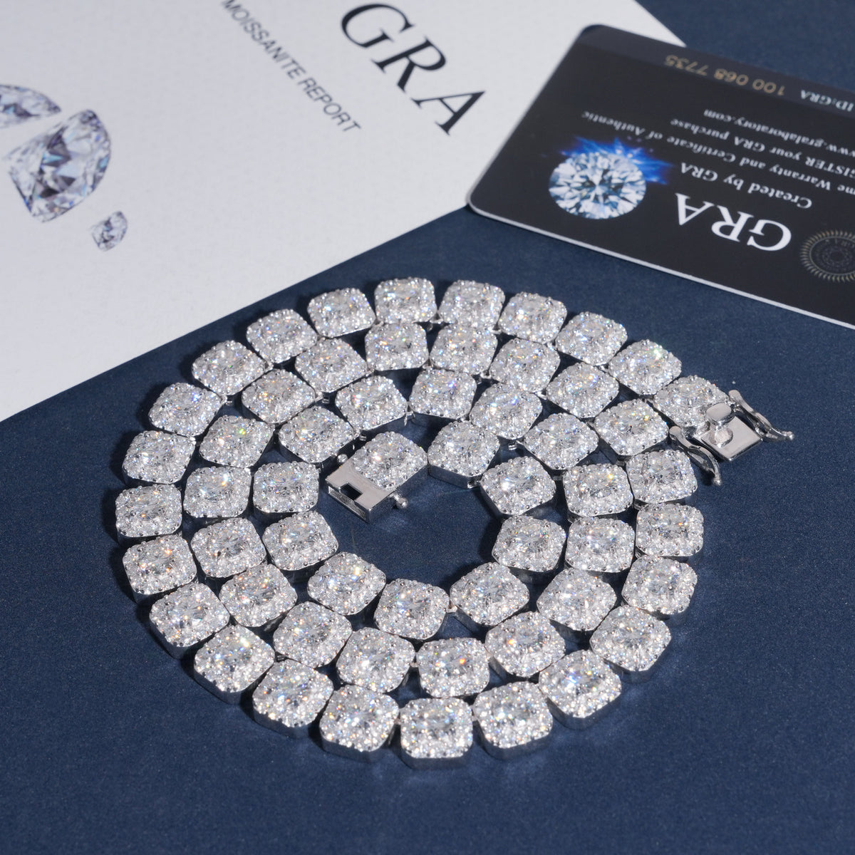 Coiled round moissanite square cushion halo tennis bracelet on navy background with GRA report