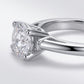 Side profile view showing prong setting and tapered baguette side stones on silver moissanite ring.