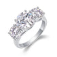 Round moissanite three stone engagement ring standing on display.