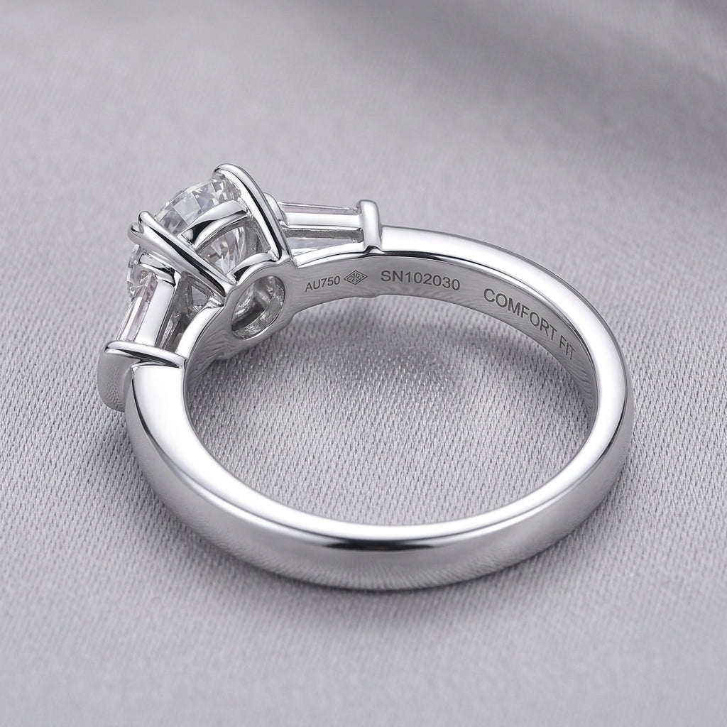 Macro view showing smooth ring band and S925 hallmark on round moissanite three-stone ring.