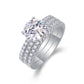 Angled view showing two piece round moissanite engagement ring and pave band set.