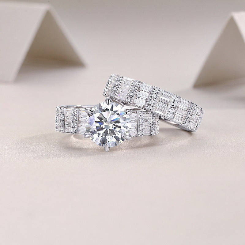 Two piece wide baguette moissanite bridal ring set resting on decorative background.