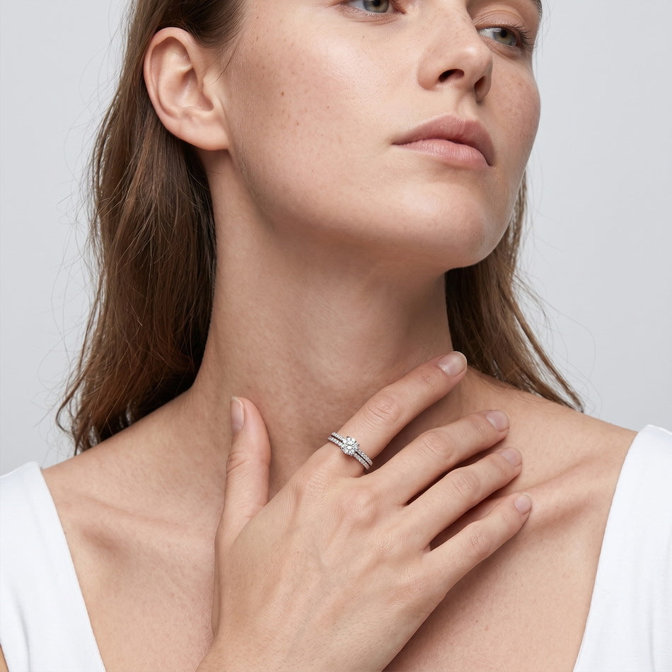 Lifestyle view of model showcasing round solitaire pave stacking ring set.