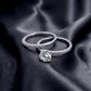 Classic round solitaire ring and matching pave band shown separately on dark silk.