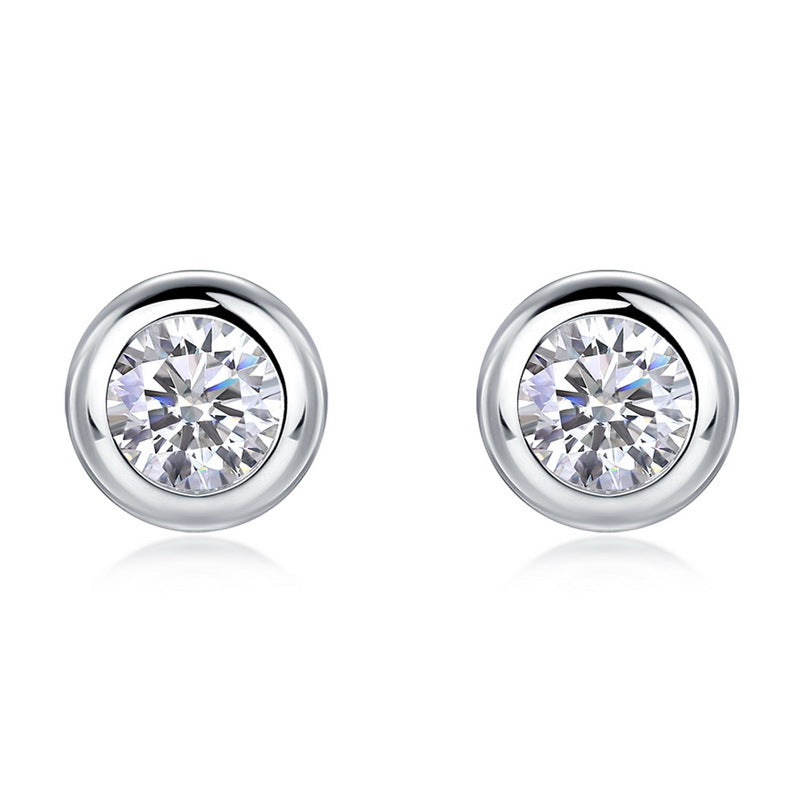Pair of round solitaire bezel set diamond stud earrings in 925 sterling silver.