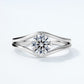 Front perspective view of round brilliant swirl bypass engagement ring.