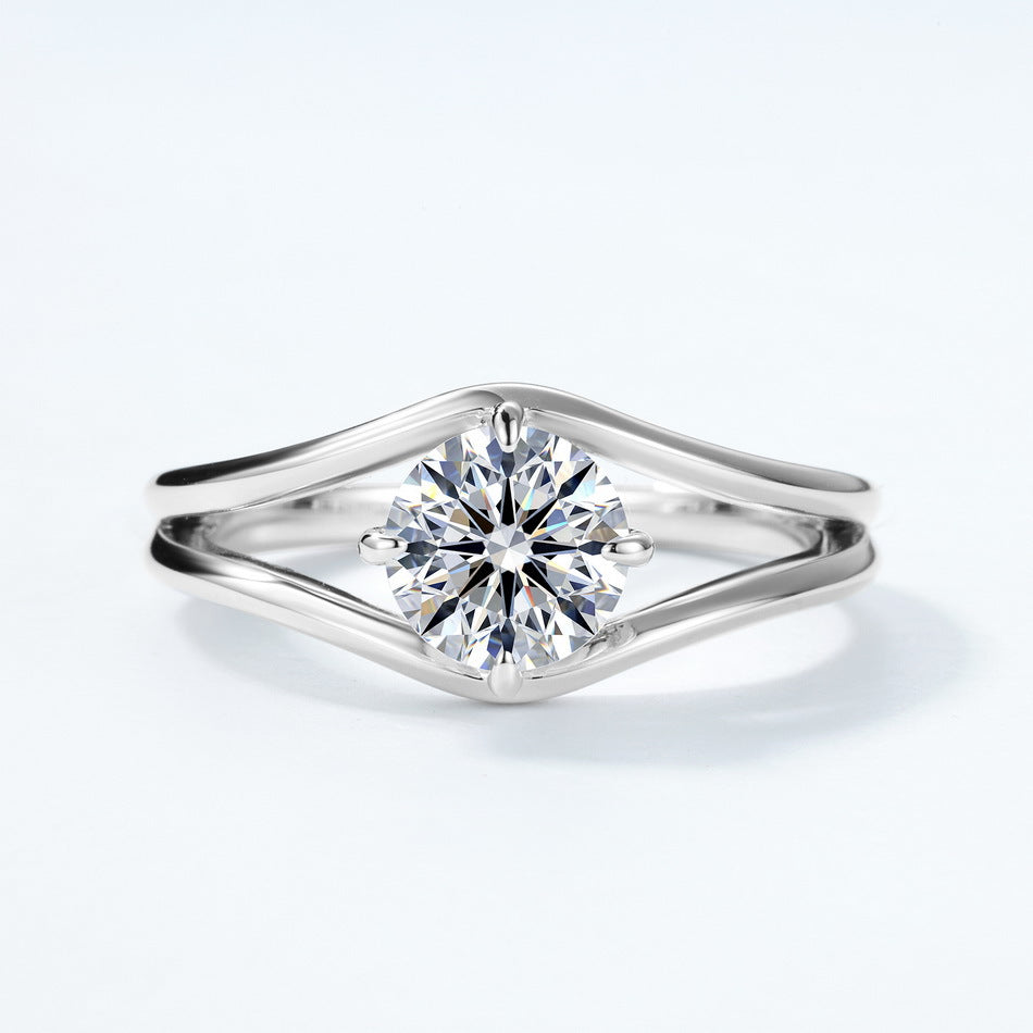 Front perspective view of round brilliant swirl bypass engagement ring.