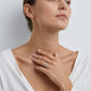 Model wearing round brilliant lab grown diamond woven infinity solitaire ring.