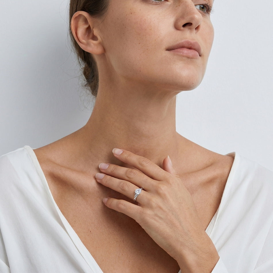 Model wearing round brilliant lab grown diamond woven infinity solitaire ring.