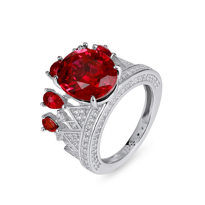 Close-up side view of a vintage crown ruby cocktail ring showcasing detailed sterling silver craftsmanship.