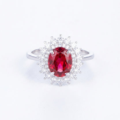 2ct oval-cut ruby Diana halo statement ring with sparkling diamond imitation border.