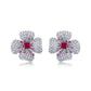 Elegant ruby four-petal flower stud earrings in gold setting for women.