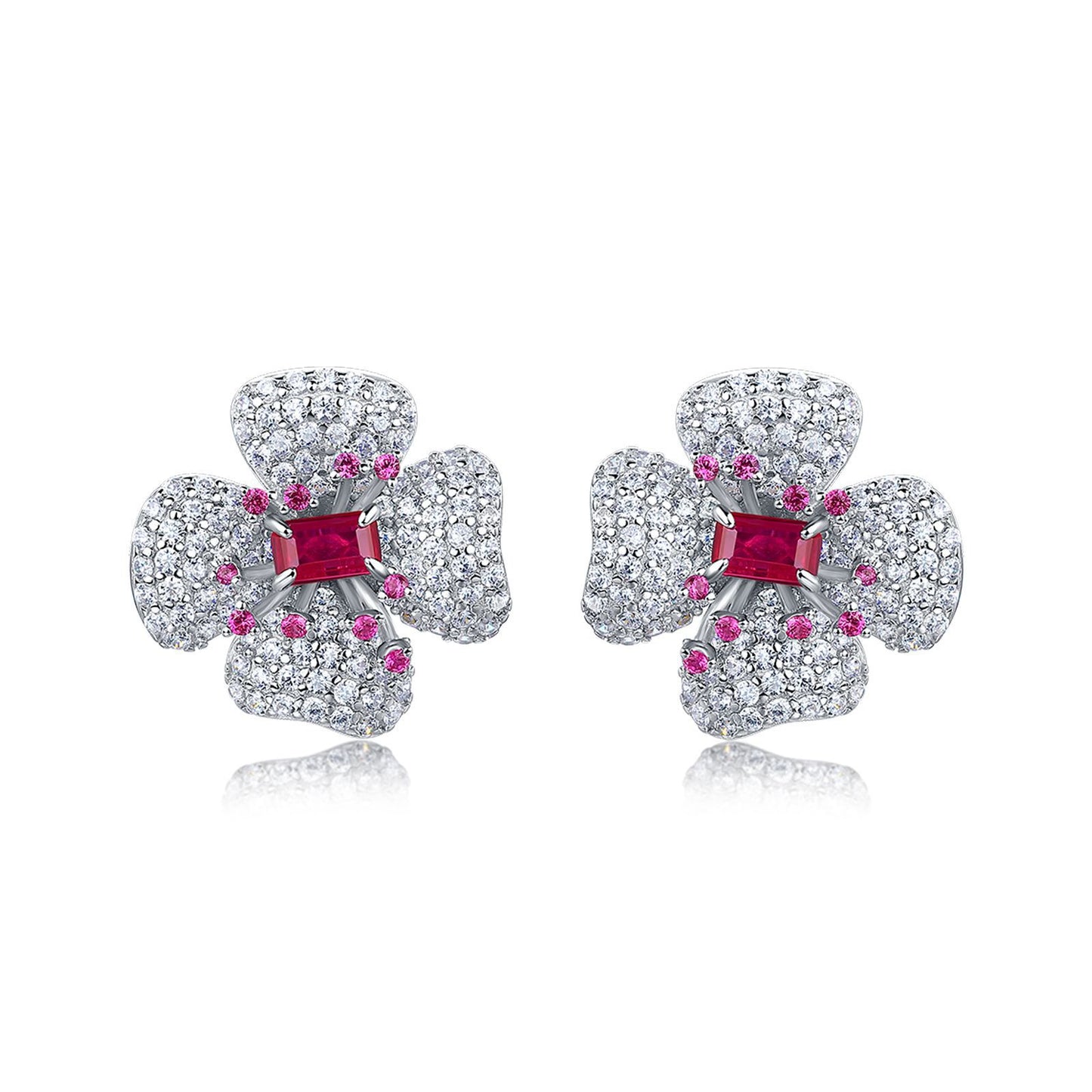 Elegant ruby four-petal flower stud earrings in gold setting for women.