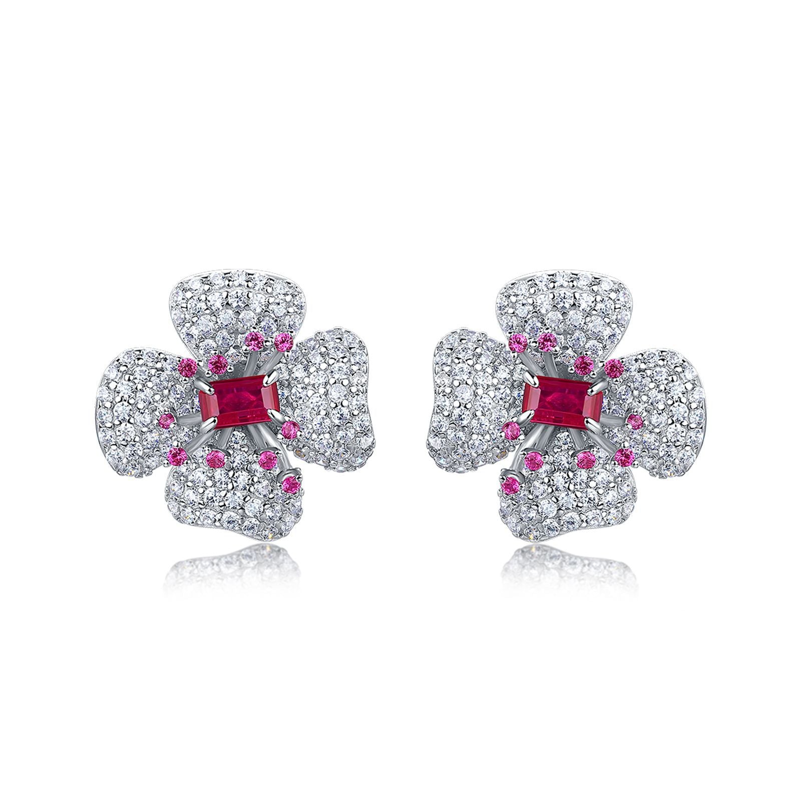Elegant ruby four-petal flower stud earrings in gold setting for women.