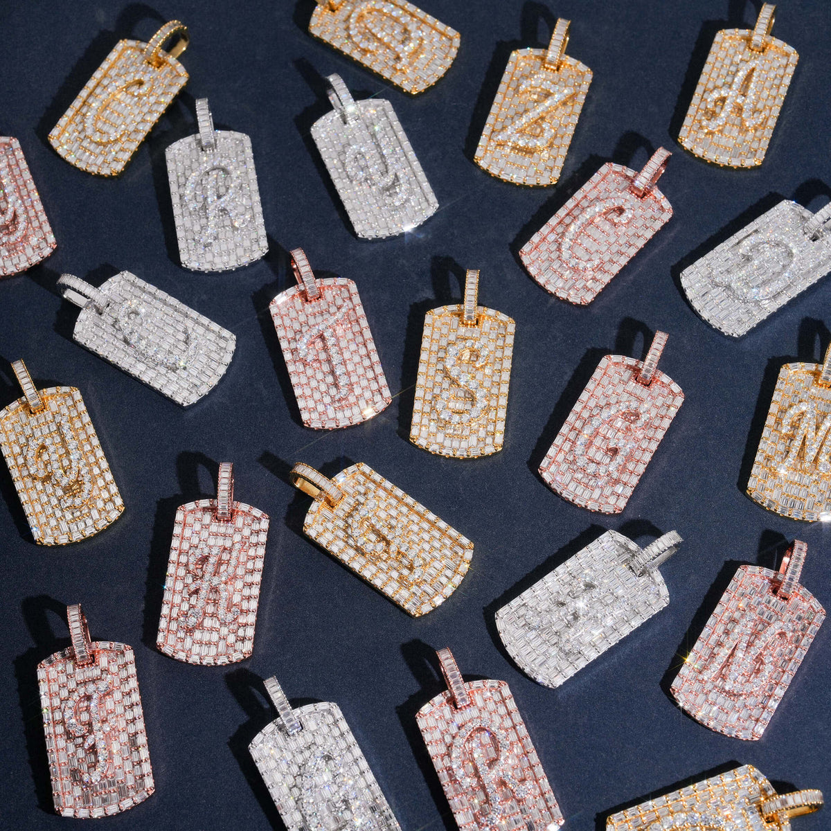 Full A-Z initial set of S925 silver iced out moissanite baguette dog tag pendants arranged in grid